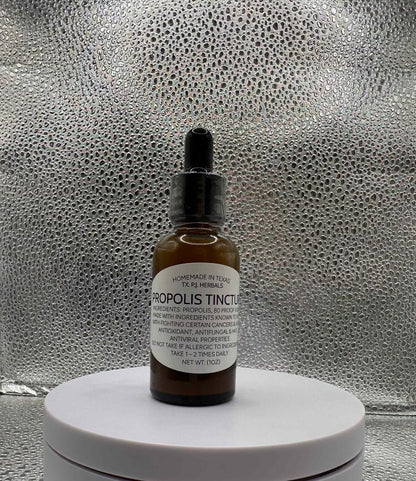 Bottle of All-Natural Propolis Tincture with wooden dropper and honeycomb background